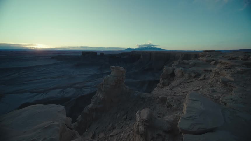 A region with many rocks in a morning and in the background there are mountains