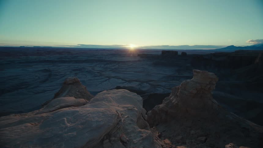 Aerial of a mountain range in a desert valley during sunset
