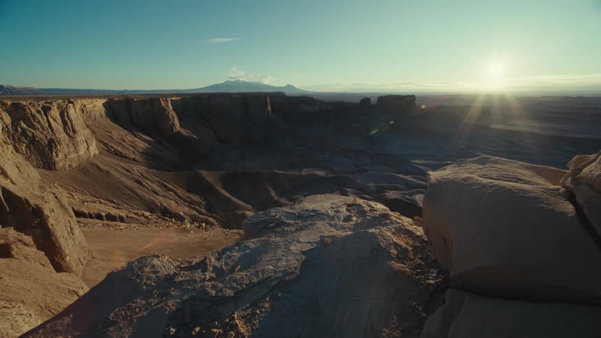 Panoramic view of valleys with rocky and geological formations with the sun on the horizon