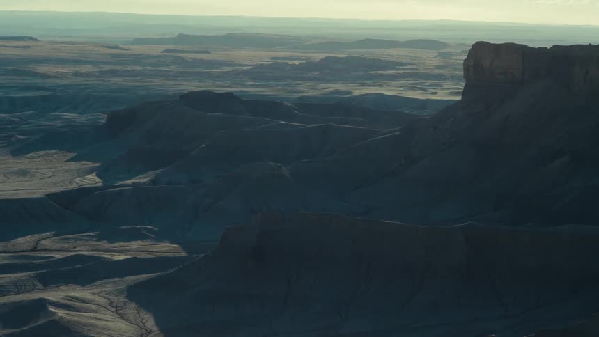Aerial of a mountainous desert with brown soil
