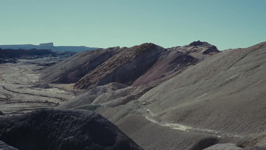 An allgray mountain range is shown against the blue sky