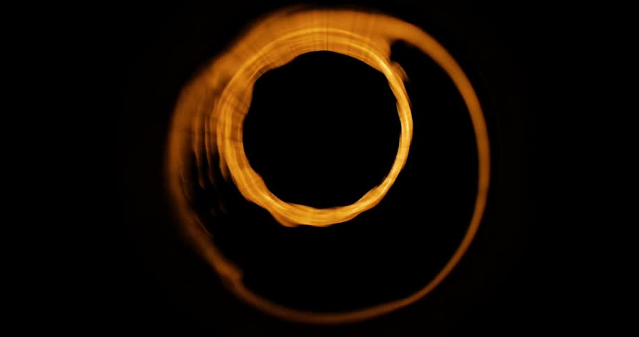 Closeup of a cylindrical beam of light amidst a shadow