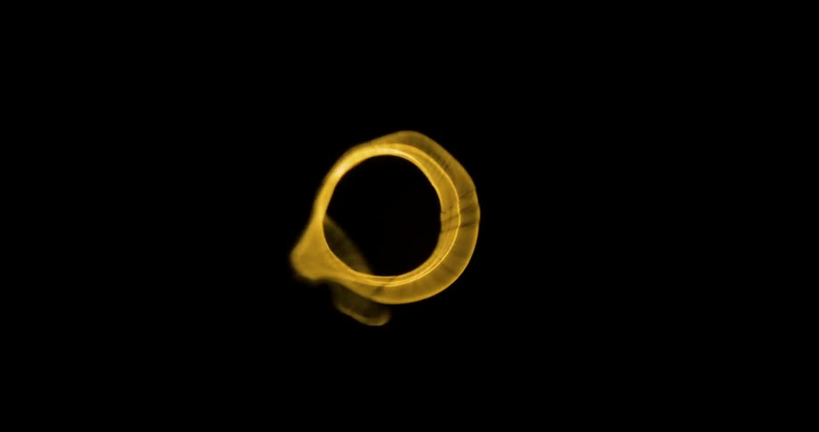 A bright yellow circle spins quickly in the darkness
