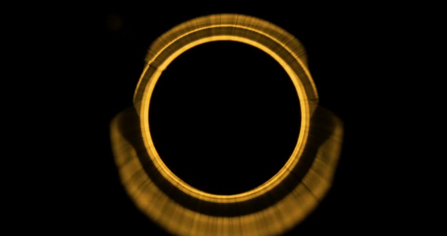 Golden light illuminates pipe wallscontrasting with surrounding darkness