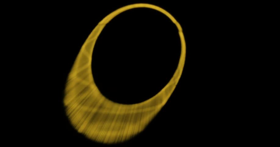 A circle of yellow light distended into an oval shape