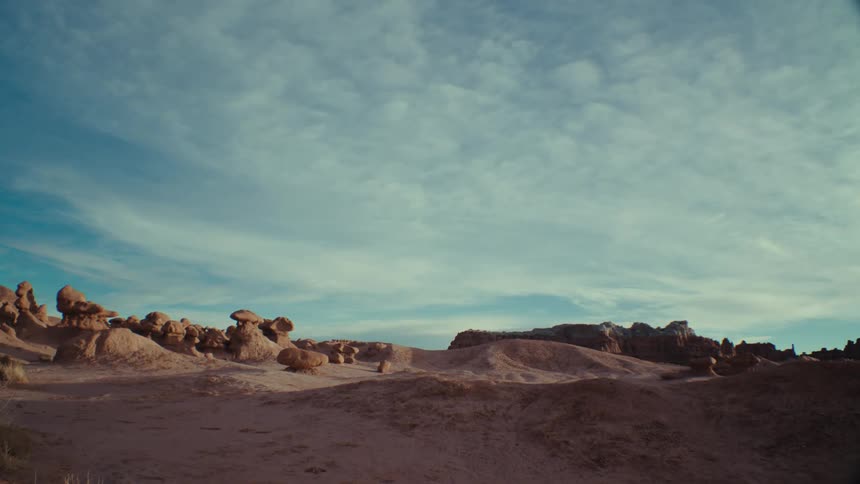 View of a desert terrain with geological rocks on a day with a blue sky and clouds