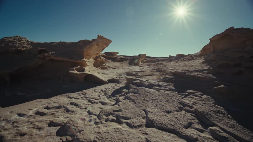 Desert terrain with rocks and valleys on a cloudless sunny day