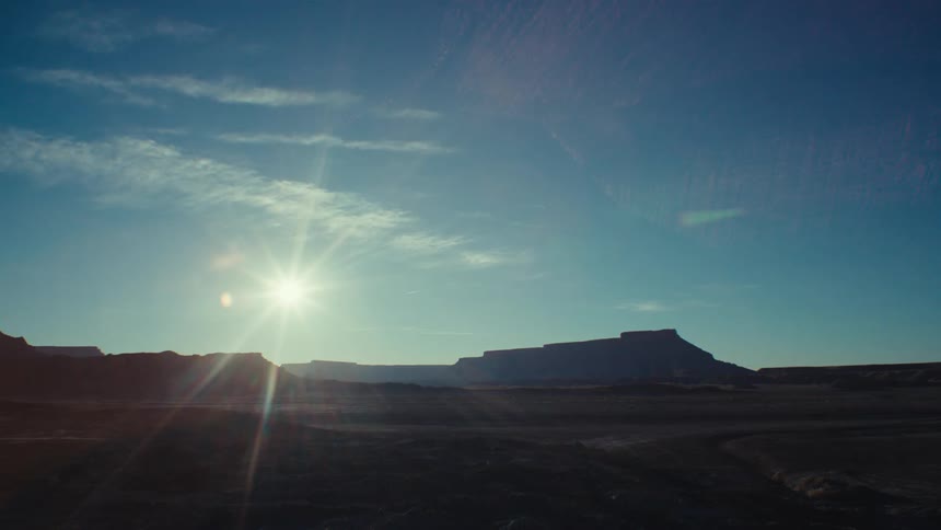 Chain of geological valleys with the sun on the horizon