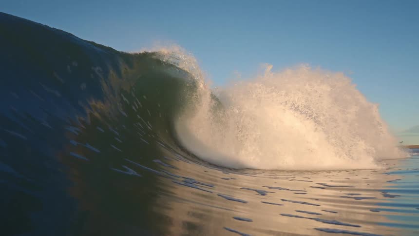 A large ocean wave is breaking and forming a tube in Orange County, California