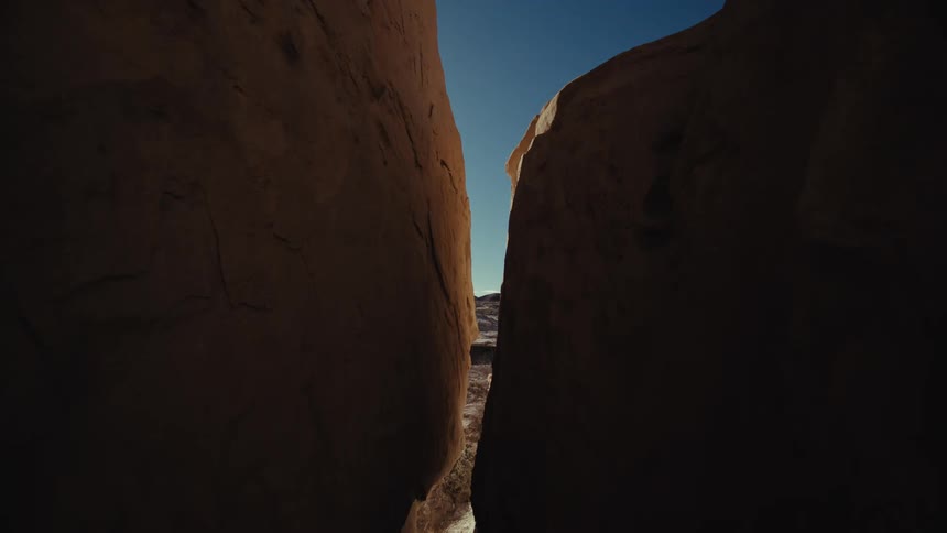 Closeup of geological rocks with a view on a beam under a blue sky