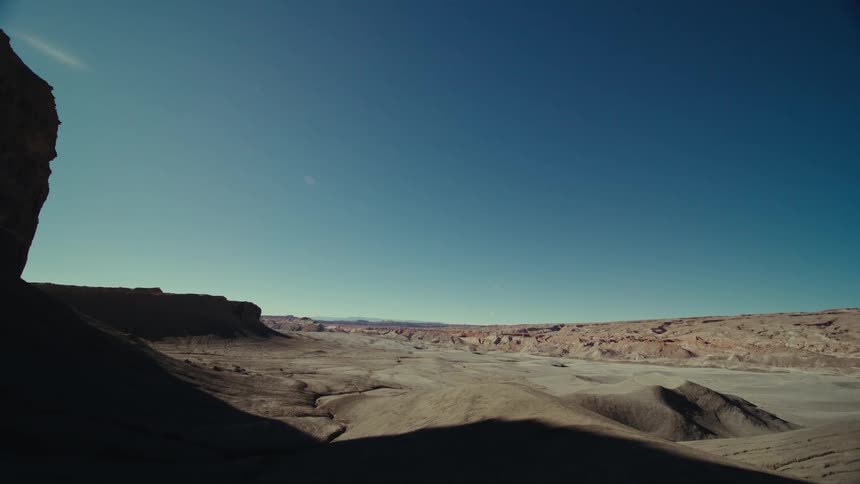 View of a rocky terrain amidst valleys on a cloudless day with a blue sky