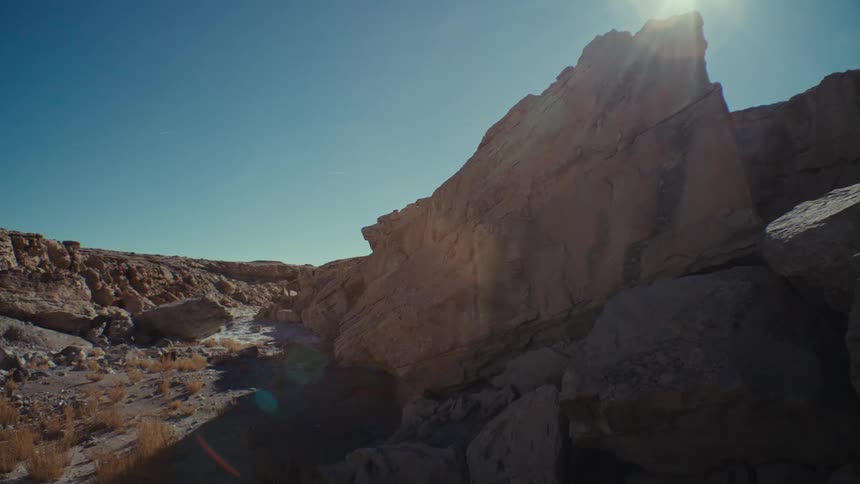View of geological rocks in a desert terrain under a blue sky