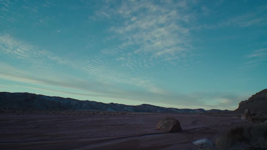 A desert with canyons during sunset