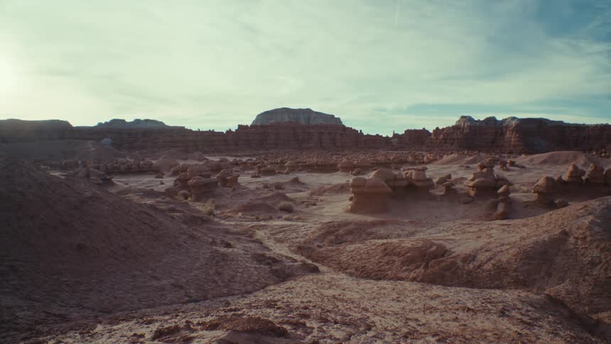 A region with rock formations and small mountains of stones on sandy soil