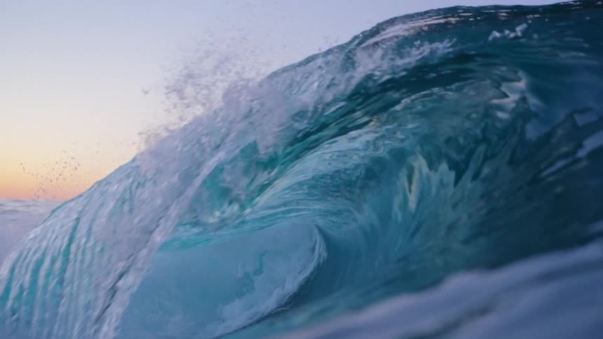 A large wave breaking and forming a tube in the middle of it