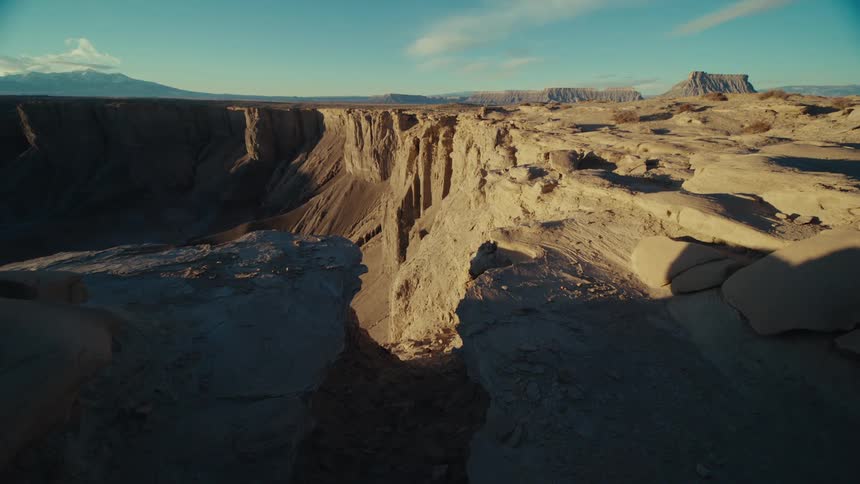The sun shines in a canyon on a bright blue day