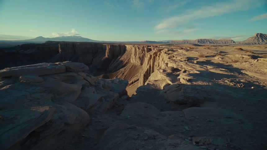 Aerial panorama of a valley with a crater on a morning with a blue sky