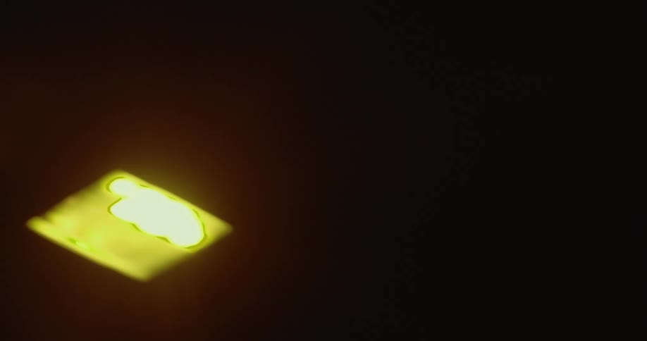 Upward view of yellow lights in a dark environment