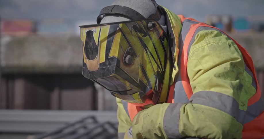 Closeup of a man with a protective helmet performing welding