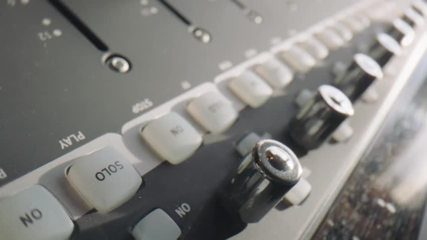 A persons finger setting up a musical instrument