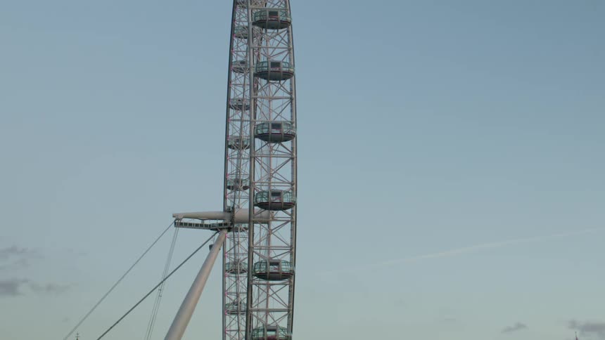 London Eye ferris wheel slowly rotating during sunset