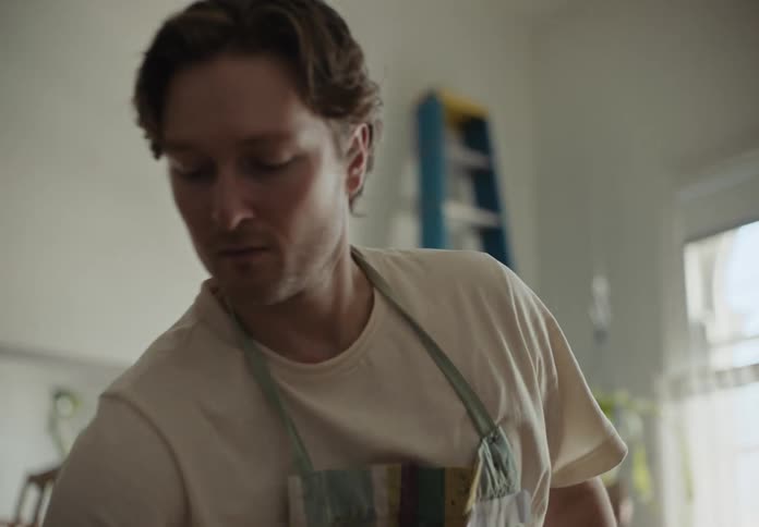 Portrait of a painter adjusting a canvas on an easel