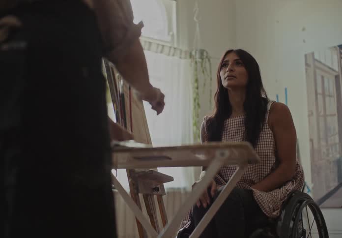 Two people having a conversation in a room