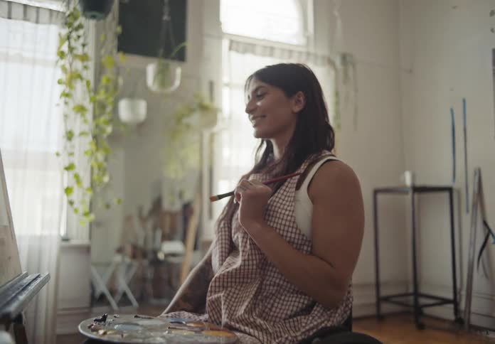 A clip of a lady painting in the room