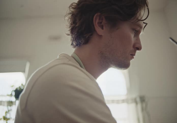 Closeup of a focused man painting a canvas