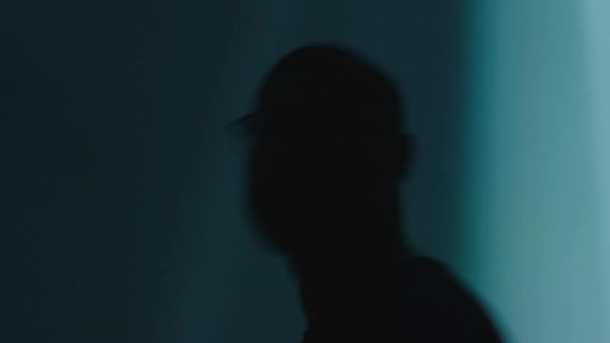 Silhouette of a mans face in a dark environment with lights