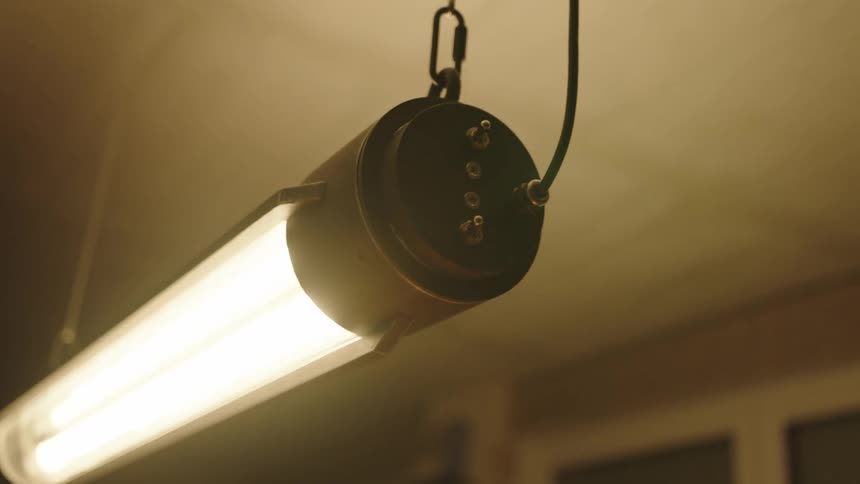 Close up of a fluorescent lamp hanging from the ceiling