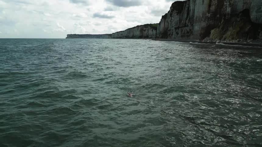 Person swimming inside the sea during the day