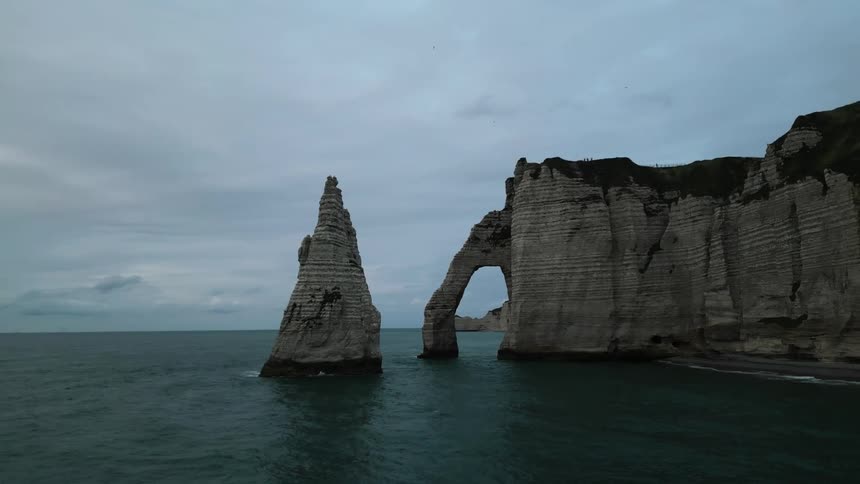 Panoramic view of the sea coast with the cliffs and the calm sea on a cloudy day