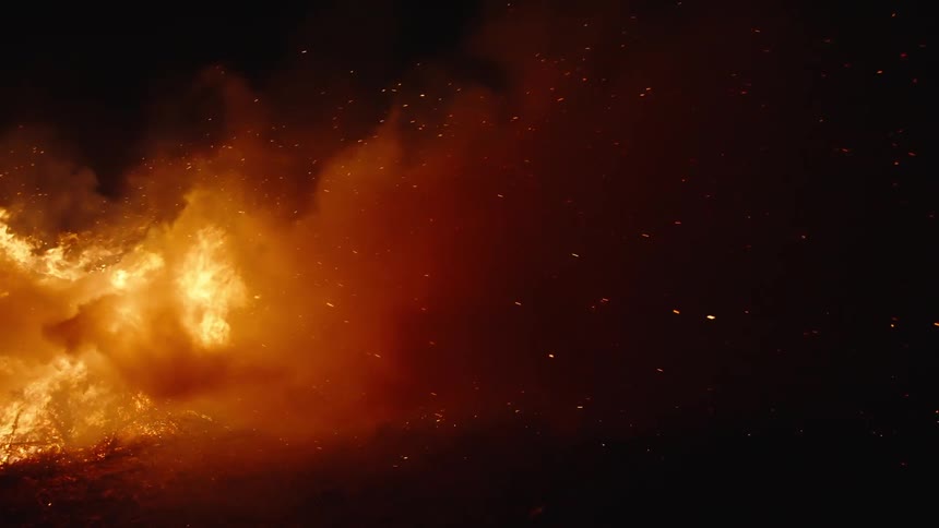 A big bonfire with lots of smoke at night