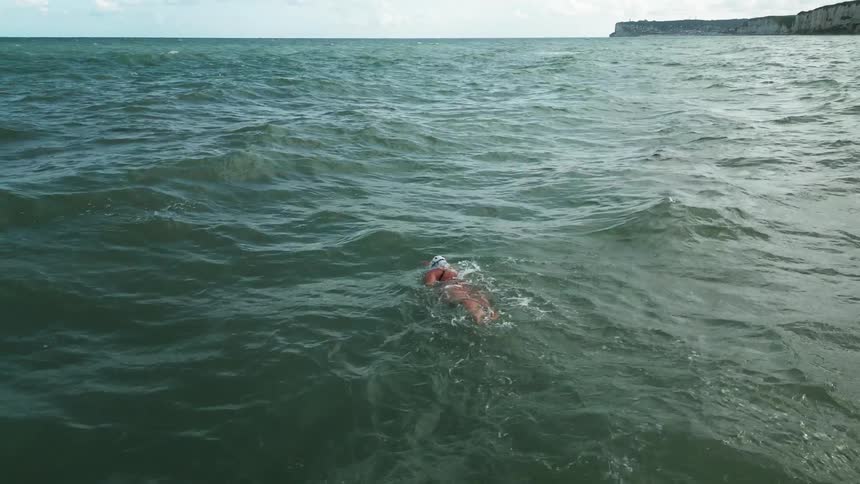 Woman swimming in the middle of the sea