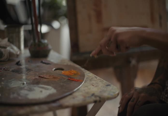 Two women mixing inks to use in paintings