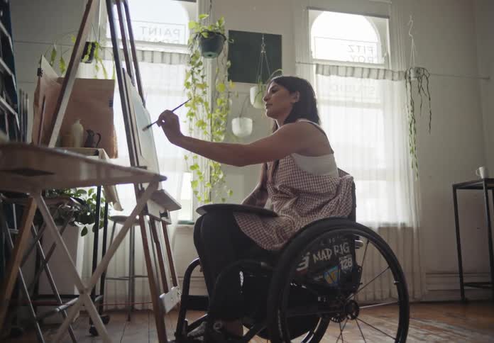 Wheelchairbound woman painter painting a picture