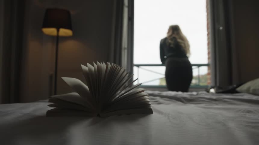 A clip of a female standing outside the room by the balcony
