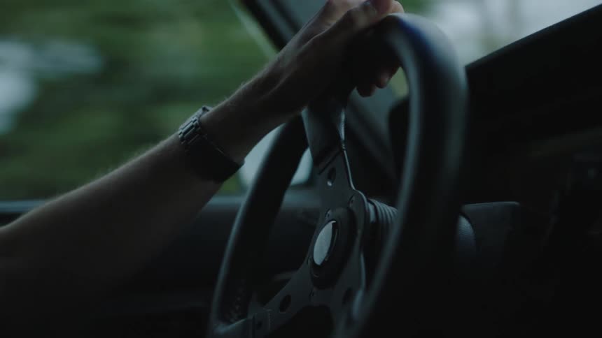 Closeup of a persons arm while driving a car