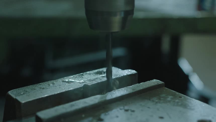 Closeup of a power tool drilling into metal