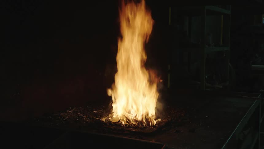 A campfire burning outdoors at night