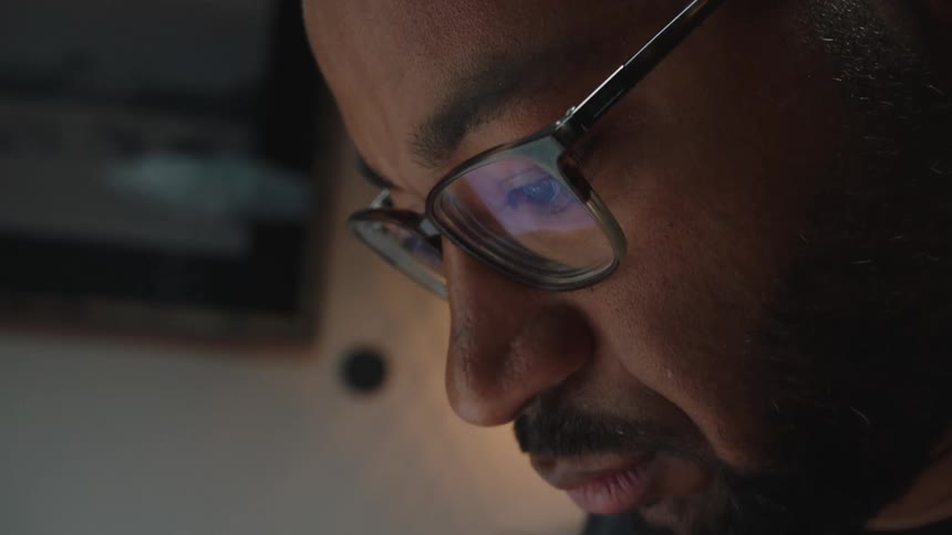 Closeup of a mans face wearing eyeglasses analyzing something