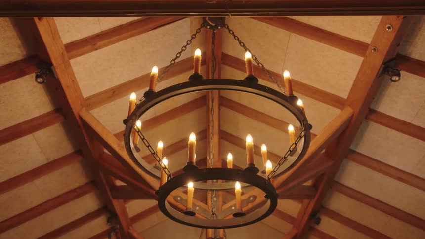 A candle chandelier hanging from the roof