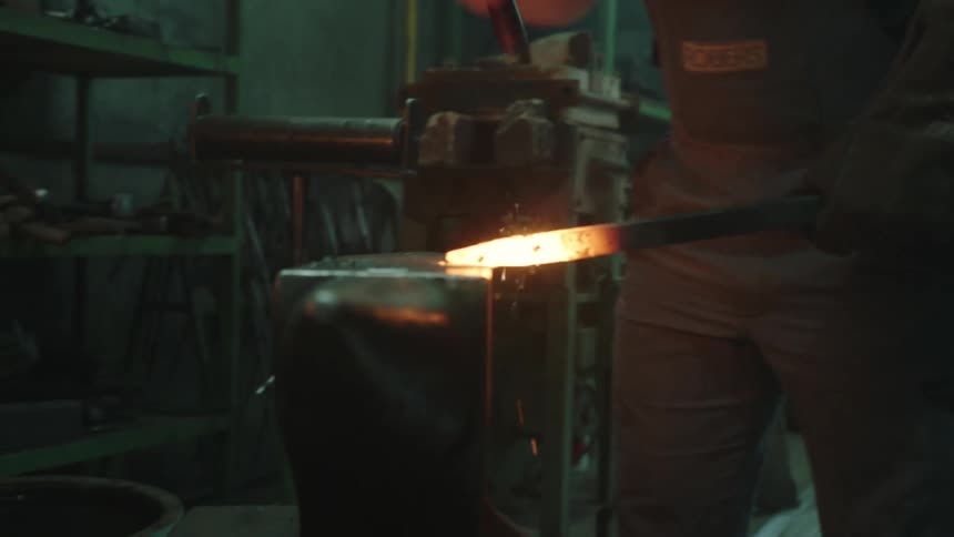 Man hammering hot iron