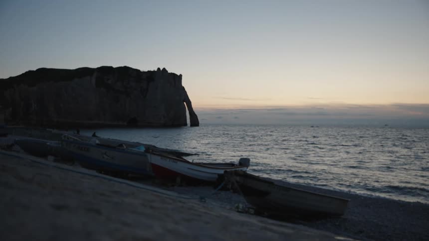 The sun is rising on the beach