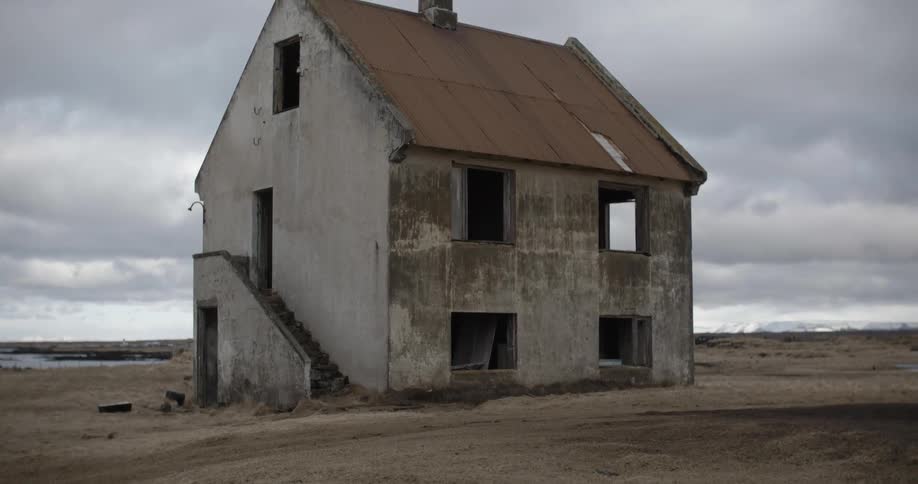 A dirty shell of a building on a cloudy day