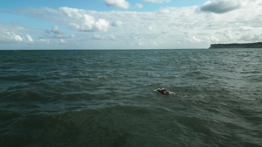 Woman swimming in the midst of the ocean