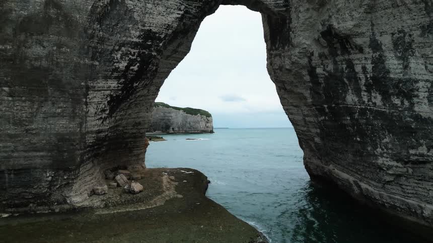 Panorama of the sea coast with a hole in the middle of the ocean on a cloudy day