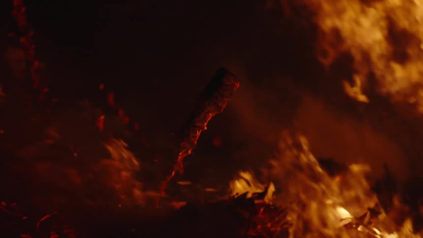 A bonfire is burning some kindling and there are very loud flames of fire