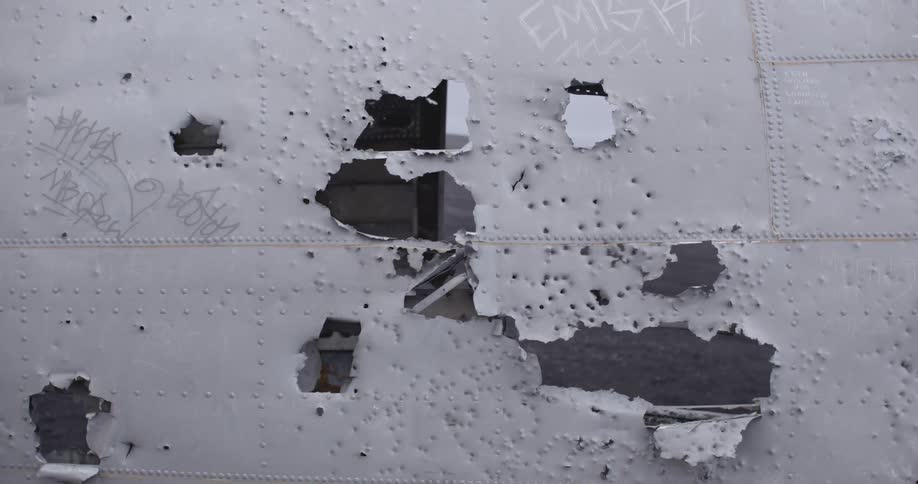 A metal wall is broken and drawn on